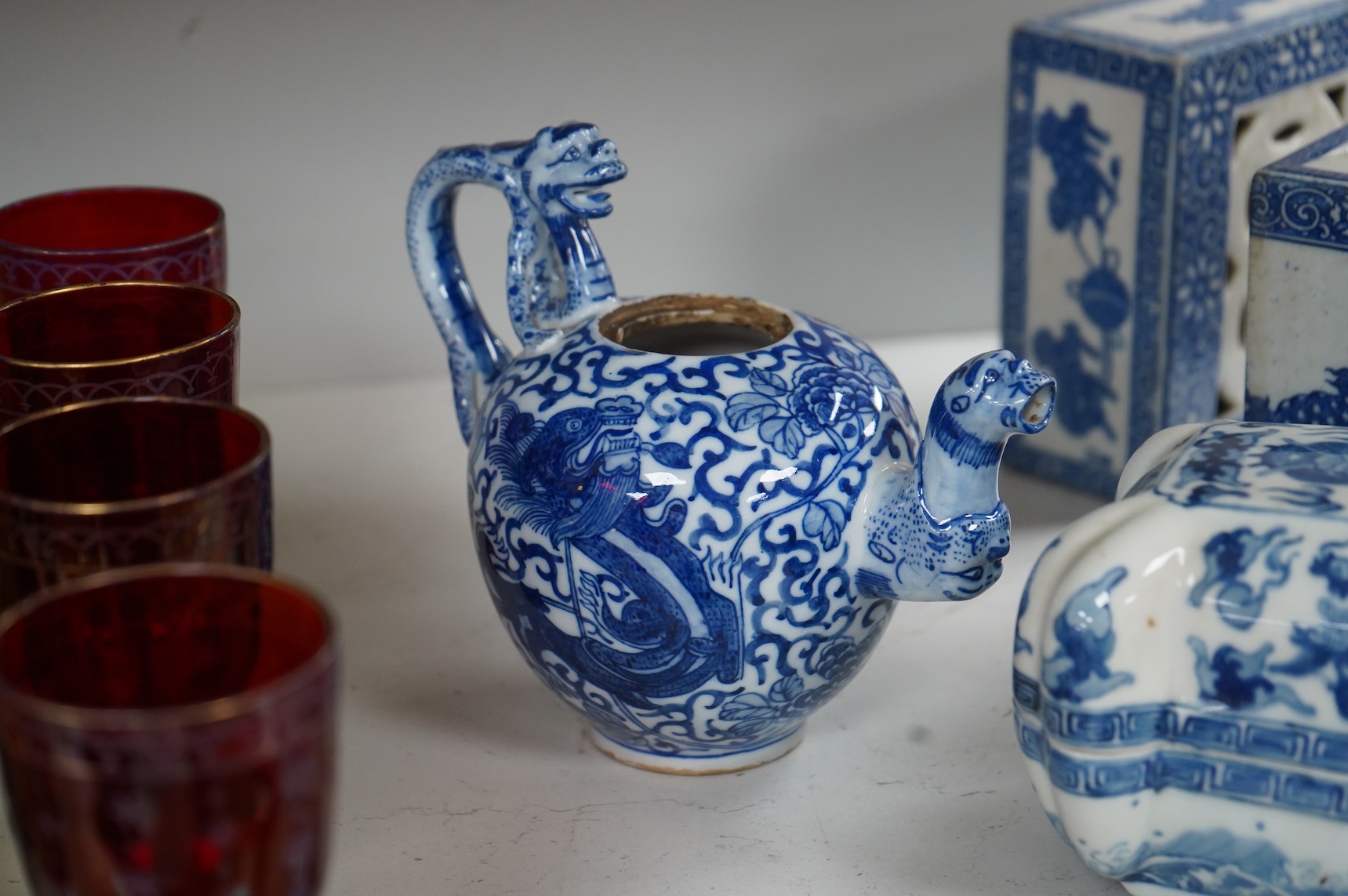 A group of Chinese blue and white comprising a dish and cover, two pillows, waterdropper and a teapot, largest 26cm wide